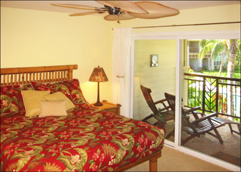 Private second floor master bedroom with big green views furnished with handsome bamboo furniture, a ceiling fan and a small lanai